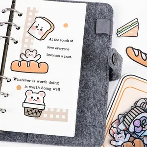 Cute cartoon food PET stickers featuring bears and bread on a gray felt journal cover