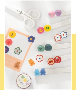 Close-up of cute cartoon bear and flower washi tape stickers for journal decoration