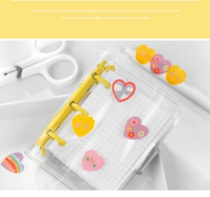 Close-up of heart-shaped cartoon stickers with 3-ring binder for journal decorating