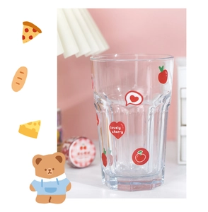 Detail of a heat-resistant glass cup featuring cute cherry and red heart prints