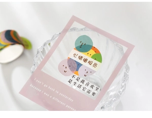 Close-up of decorative washi tape sticker with cartoon face on a glass cup