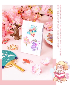Detail of pink cherry blossom stickers and gift bag with anime girl illustration