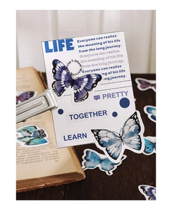Macro shot of vintage butterfly PET stickers and inspirational quotes for DIY journaling