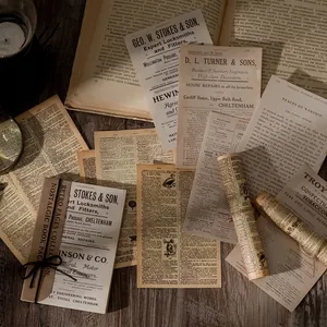 Vintage nostalgic paper kit with retro ephemera and old newspaper designs on wooden desk