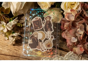 Macro shot of starry celestial PVC sticker with holographic witch and black cat details