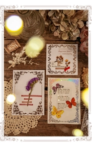 Detail of vintage decorative cards with pressed flowers, butterfly motifs and laser silver accents