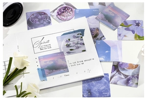 Detail of aesthetic photography stickers with floral and sky motifs on a notebook