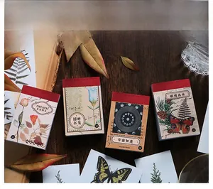 Vintage washi sticker books with botanical and butterfly designs on wood background