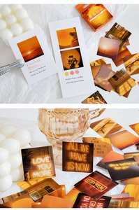 Macro detail of sunset aesthetic stickers and warm landscape cards for DIY scrapbooking