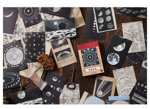 Detailed flat lay of celestial themed washi stickers with moon phases and star charts