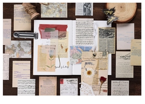 Macro shot of vintage scrapbooking paper with old maps, music notes, and botanical designs