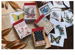 Close-up of vintage washi sticker books with botanical and butterfly illustrations