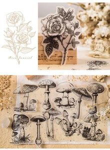 Close-up of vintage black and white plant stickers featuring roses and mushrooms for DIY art