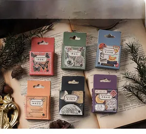 Macro shot of vintage style decorative sticker boxes for scrapbooking on an old book