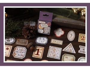 Close-up of vintage ephemera stickers and travel stamps scattered on dark wood texture