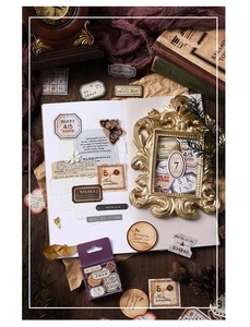 Close-up of vintage traveler series deco stickers with botanical and ticket motifs