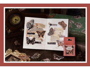 Macro detail of vintage butterfly deco stickers with antique clock and journal props