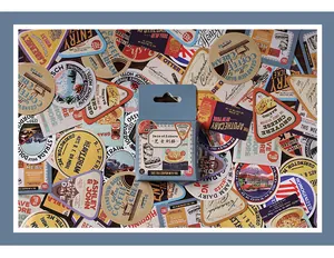 Detailed view of vintage travel and food labels stickers with a light blue packaging box