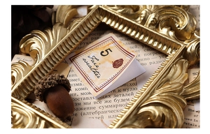 Detail of vintage traveler-themed sticker with wax seal design in an ornate gold frame