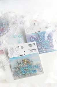 Detail shot of iridescent letter stickers with dreamy cloud patterns for DIY scrapbooking