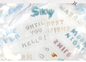 Detailed macro view of 3D textured letter stickers with dreamlike bokeh background