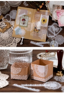 Detailed view of white PET lace stickers applied on craft paper journals and gift boxes