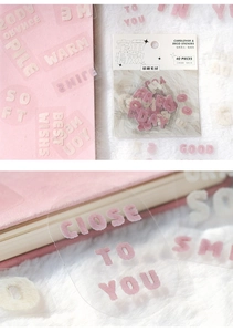 Detail showing plush texture letter stickers with English phrases on a notebook page
