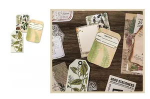 Vista macro di carta vintage con illustrazioni botaniche ed etichette scrivibili per scrapbooking