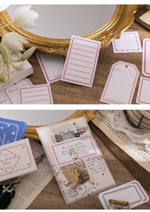 Close-up of vintage Mo-Card paper labels and stickers on a rustic wooden desk