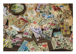 Close-up of vintage floral washi stickers with a magnifying glass on an old book
