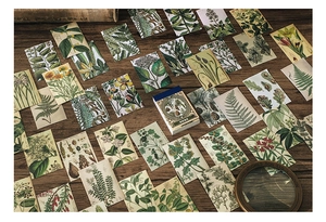 Detailed view of vintage botanical stickers with floral illustrations on a wooden table