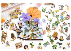 Detailed flat lay of PET stickers featuring floral, cafe, and art themes for DIY journaling