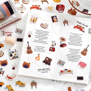 Pet stickers featuring home furniture and poems displayed on a grid notebook for DIY journaling
