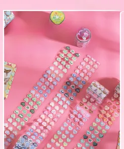 Detail of laser-cut heart stickers with holographic glitter effects for journaling
