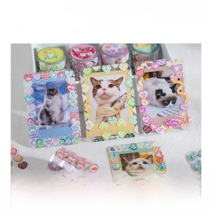Close-up of heart-shaped die-cut stickers and decorative laser tape for photo albums
