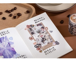 Macro detail of laser heart stickers and coffee-themed washi tape on an open notebook