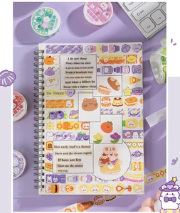 Close-up of spiral notebook with cute dessert stickers and washi tape DIY decoration