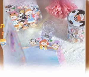 Detail of cute cow-themed washi tape set featuring cartoon girl illustrations and patterns