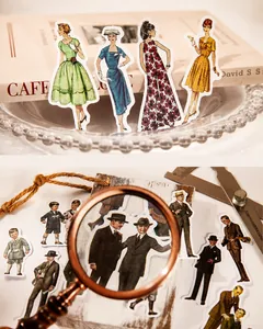 Detail of vintage fashion stickers featuring 1950s figure illustrations on an old book