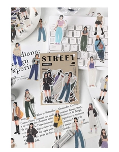 Flat lay of trendy girl fashion stickers on a keyboard with creative stationery setup