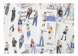 Detail of artistic girl fashion stickers on a white keyboard for DIY scrapbooking decor