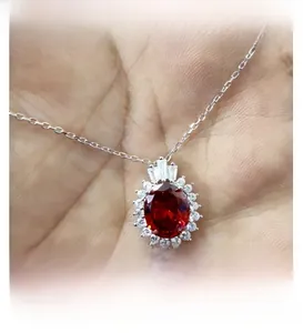 Detail shot of elegant S925 silver necklace featuring a red oval zircon and crown pendant