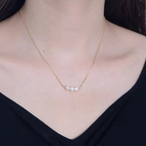 Minimalist freshwater pearl necklace with three pearls on a gold-plated silver chain