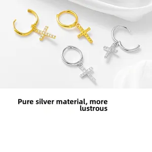 Detail of S925 sterling silver cross earrings with zircon pavé in gold and silver