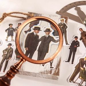 Vintage gentleman fashion stickers displayed under a magnifying glass for DIY scrapbooking