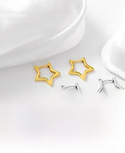 Detail of star-shaped S925 sterling silver hoop earrings in gold and silver finishes