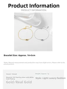 Close-up of gold and silver evil eye bracelets with cubic zirconia on white silk