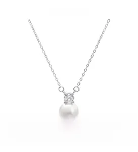Macro detail of round freshwater pearl pendant with sparkling zircon on S925 silver chain
