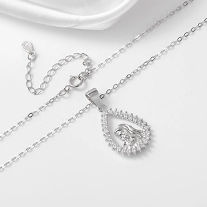 Macro detail of S925 silver Virgin Mary pendant with sparkling pavé cubic zirconia