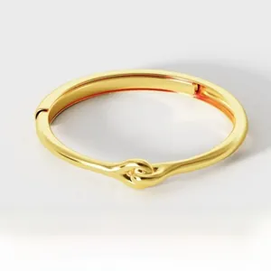 Detailed view of gold plated 925 sterling silver knotted ring with a polished finish